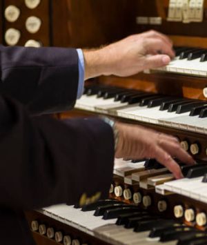 Organist hands playing on two keyboards